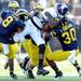 Michigan defense swarm Northwestern wide receiver Cameron Dickerson during the fourth quarter at Michigan Stadium on Saturday. Melanie Maxwell I AnnArbor.com